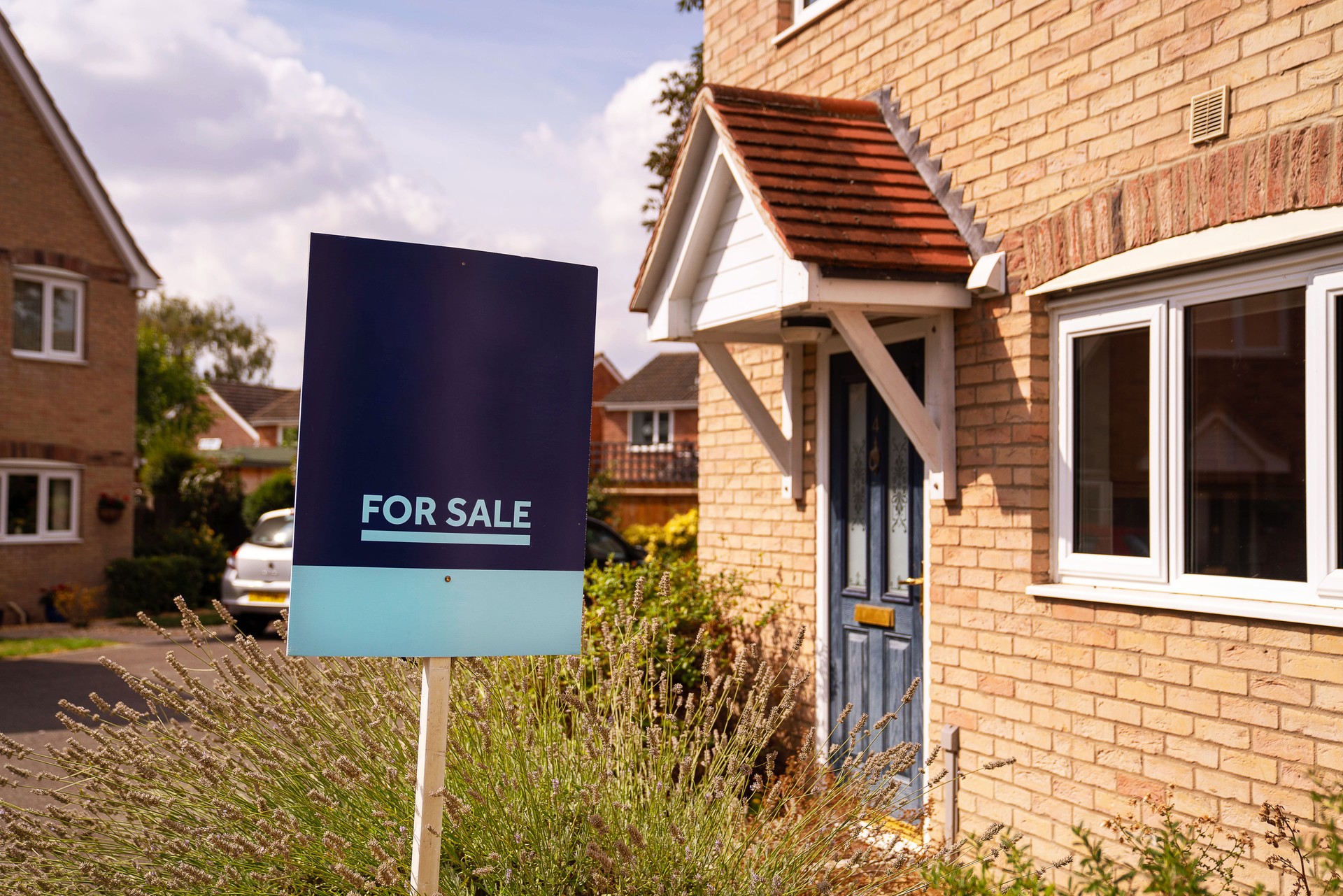 For sale sign in yard of house